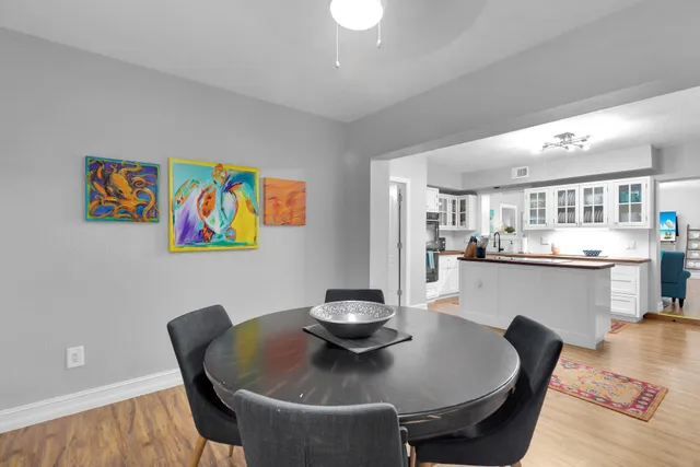 a dining room with furniture and wooden floor
