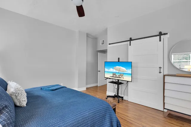 a bedroom with a bed and a mirror