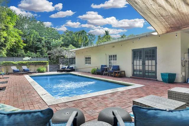 a view of a backyard with swimming pool