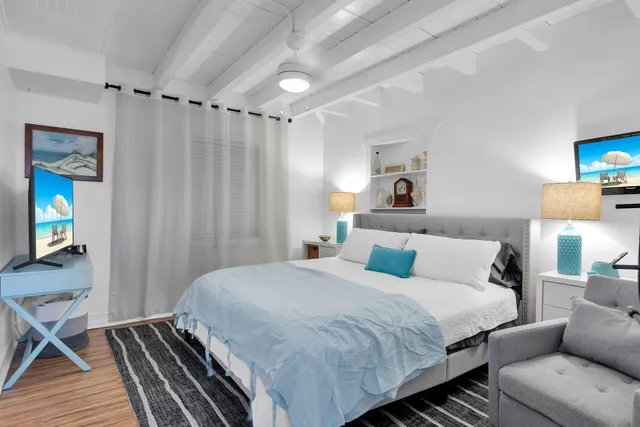 a bedroom with a bed and a wooden floor