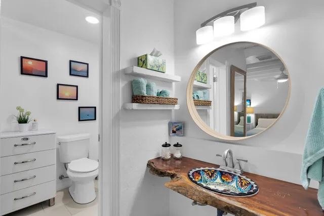 a bathroom with a toilet a sink and a mirror