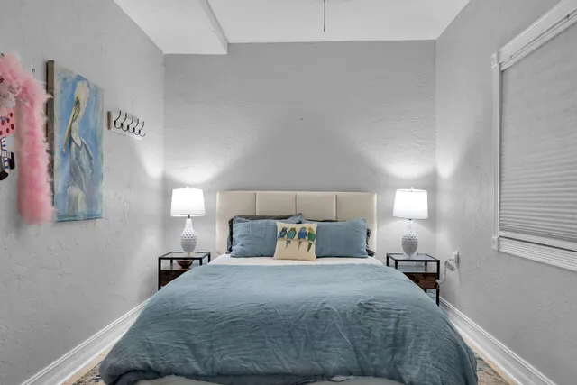 a bedroom with a bed and a night stand