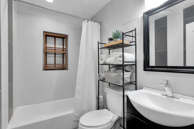 a bathroom with a sink toilet and shower