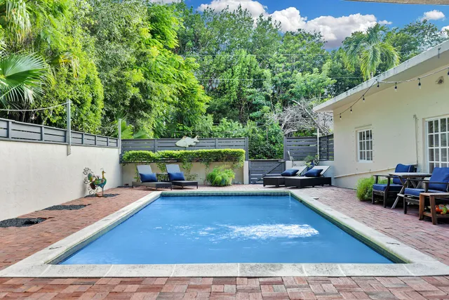 a view of a backyard with sitting area