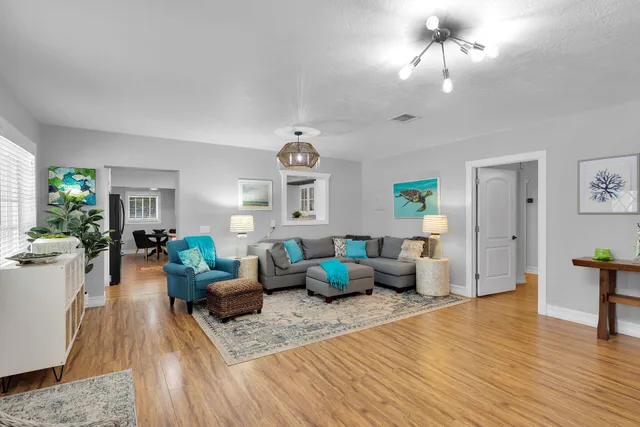 a living room with furniture and a chandelier
