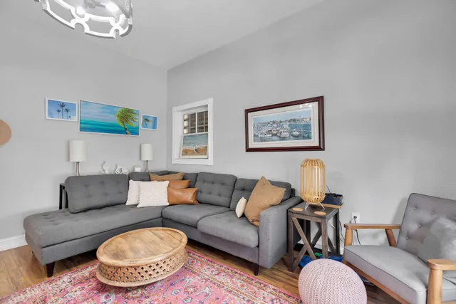 a living room with furniture a rug and a window