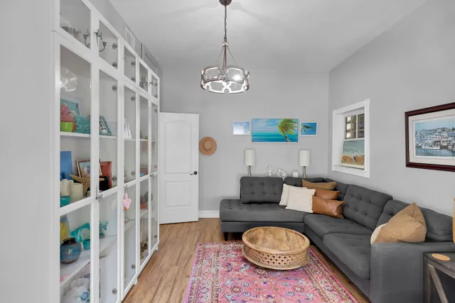 a living room with furniture a rug and a window