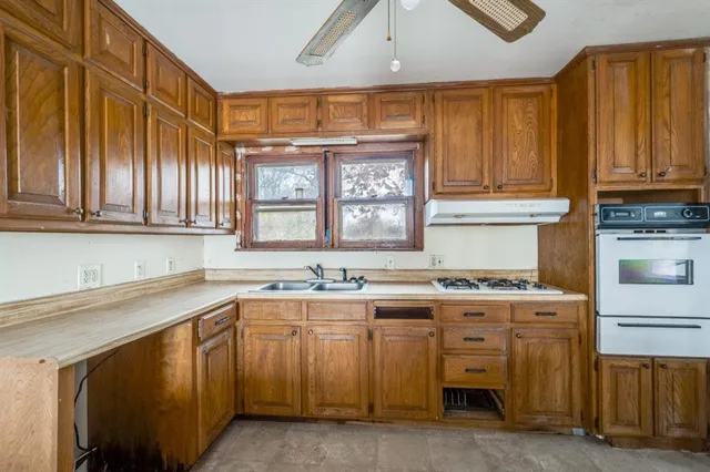 a kitchen with stainless steel appliances granite countertop a stove and a sink
