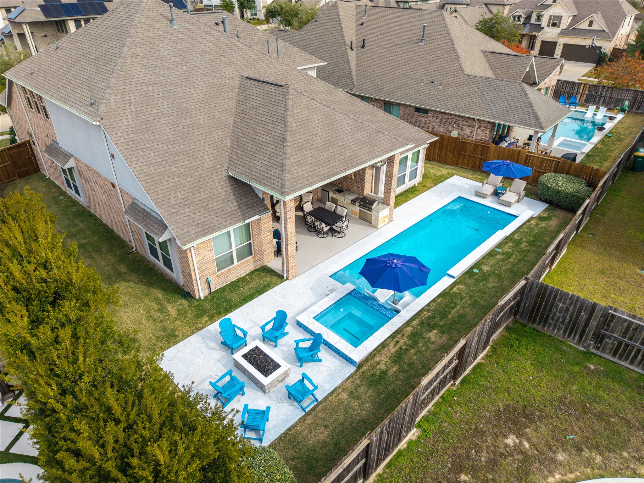 18307 Whistling Hills Road Cypress, TX 77433 - Photo 2 of 43 Completed in January 2025, the resort-style pool and fire pit along with the covered outdoor kitchen set the stage for the ultimate backyard experience.