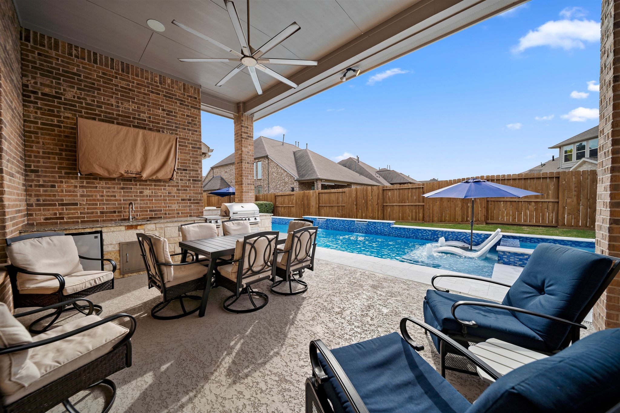 18307 Whistling Hills Road Cypress, TX 77433 - Photo 31 of 38 Welcome to an entertainer’s paradise—this fully covered outdoor kitchen with grill and beverage fridge overlooks the spectacular pool area.