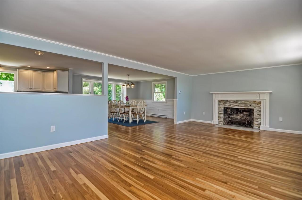 56 Elgin Road Pocasset, MA 02559 - Photo 13 of 35 an empty room with wooden floor and fireplace