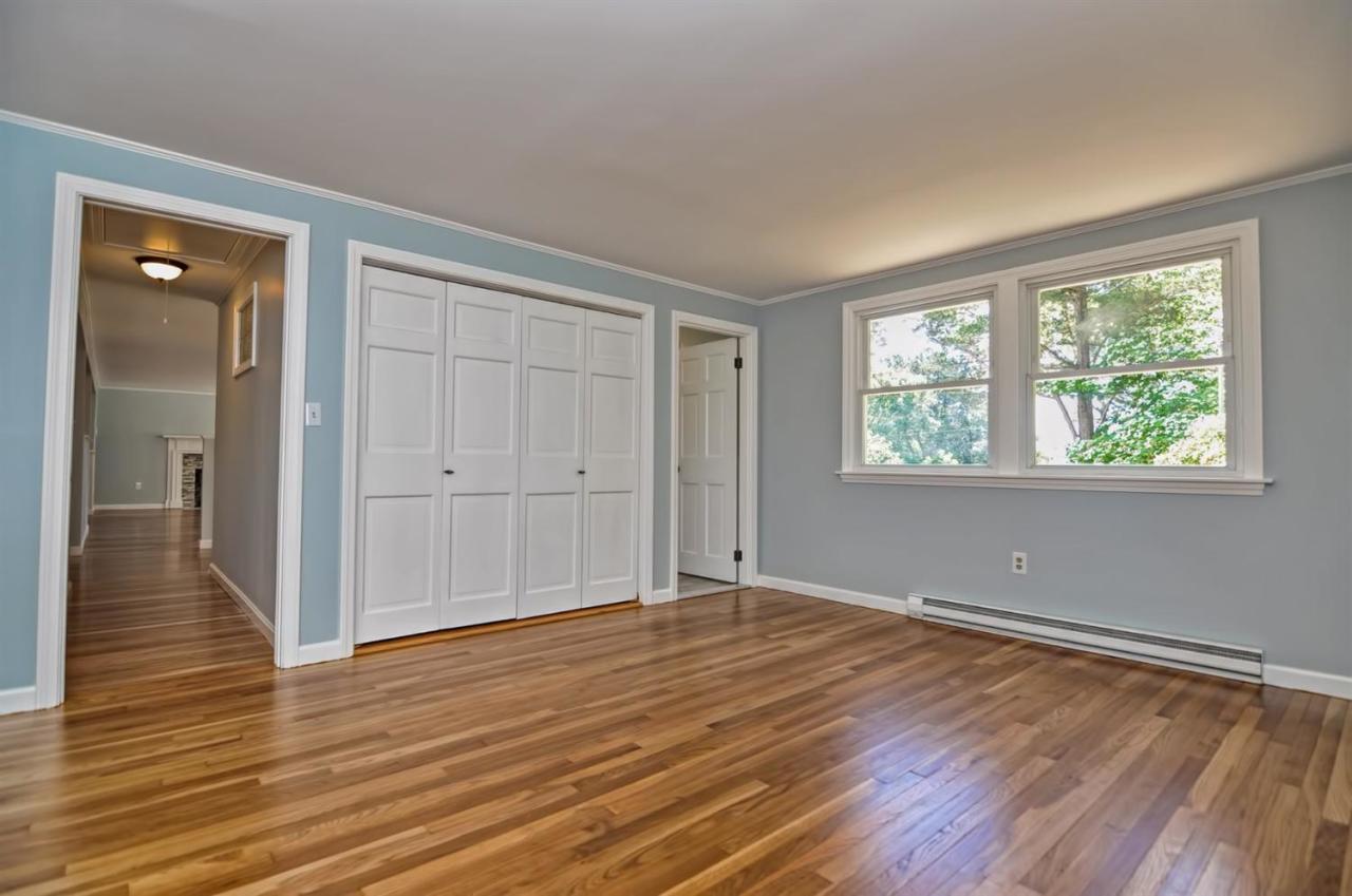 56 Elgin Road Pocasset, MA 02559 - Photo 14 of 35 a view of an empty room with wooden floor and a window