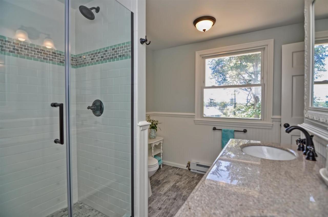 56 Elgin Road Pocasset, MA 02559 - Photo 18 of 35 a bathroom with a granite countertop tub sink a window and a shower