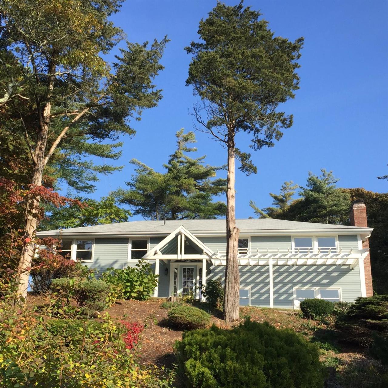 56 Elgin Road Pocasset, MA 02559 - Photo 2 of 35 a front view of a house with a yard