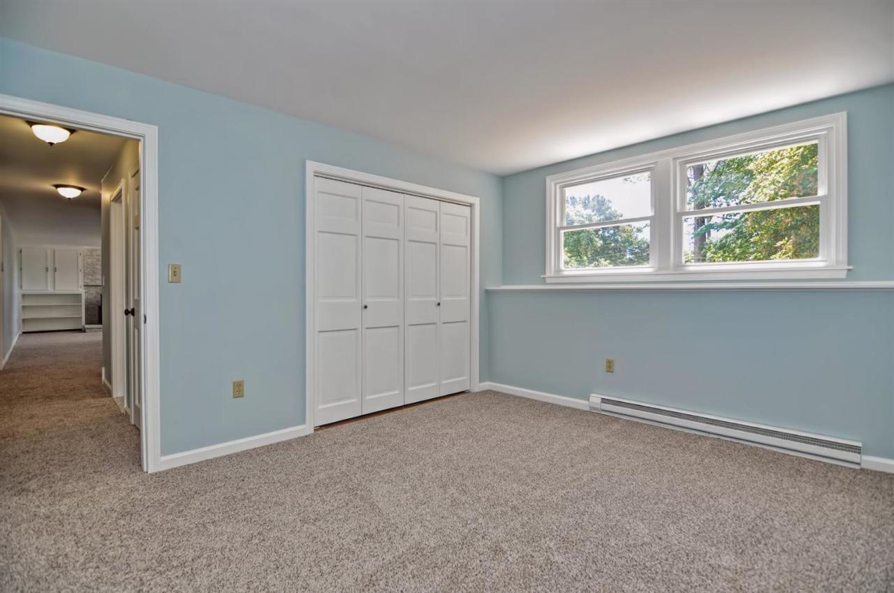 56 Elgin Road Pocasset, MA 02559 - Photo 28 of 35 an empty room with windows and closet
