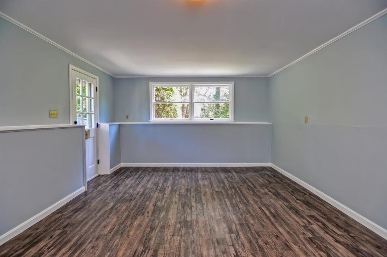 56 Elgin Road Pocasset, MA 02559 - Photo 31 of 35 an empty room with wooden floor and windows