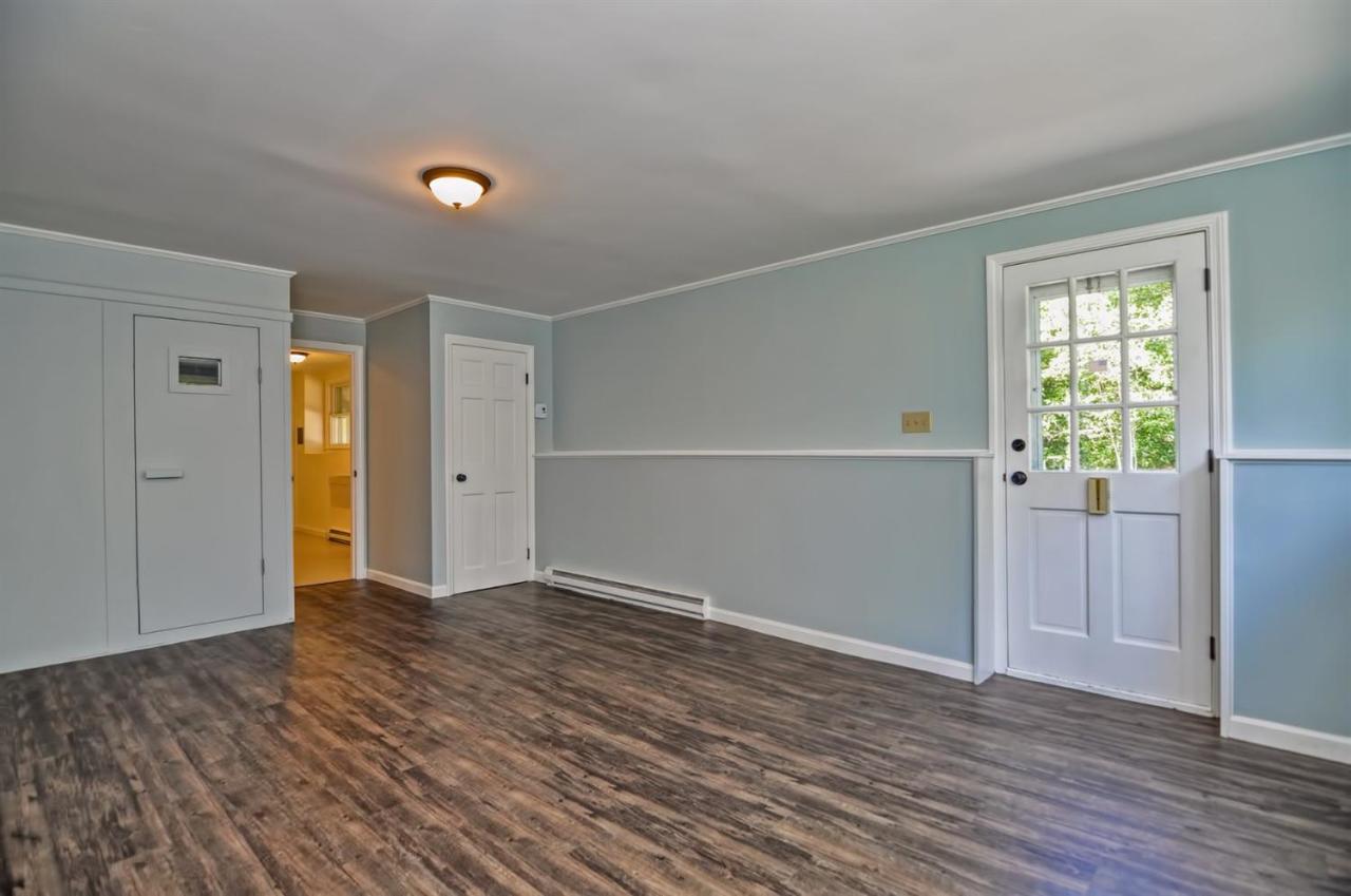 56 Elgin Road Pocasset, MA 02559 - Photo 32 of 35 a view of an empty room with wooden floor and a window