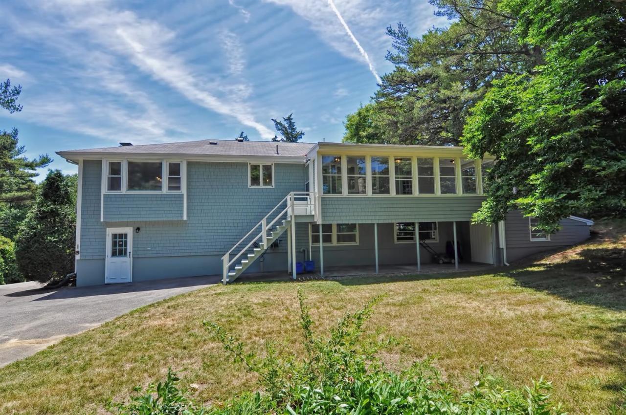 56 Elgin Road Pocasset, MA 02559 - Photo 7 of 35 a view of a house with a yard and sitting area