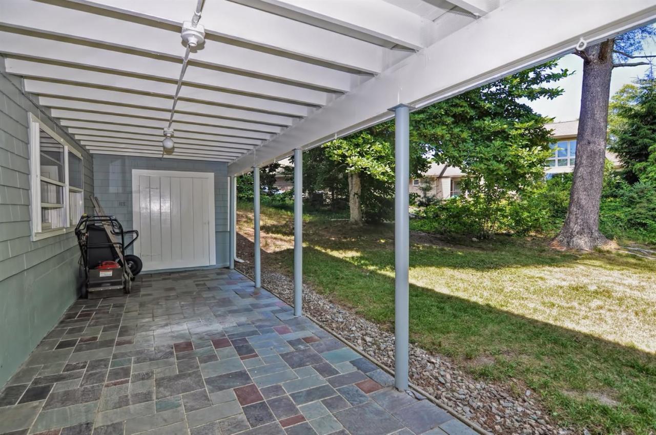 56 Elgin Road Pocasset, MA 02559 - Photo 8 of 35 a view of a porch with chairs and backyard