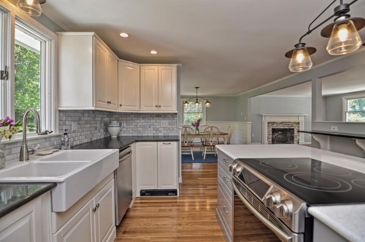 56 Elgin Road Pocasset, MA 02559 - Photo 9 of 35 a kitchen with a sink stove and cabinets