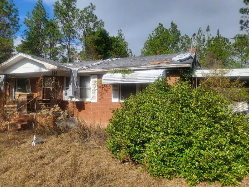 546 Alton Lawson Road Adrian, GA 31002 - Photo 2 of 29 a view of a patio with table and chairs under an umbrella