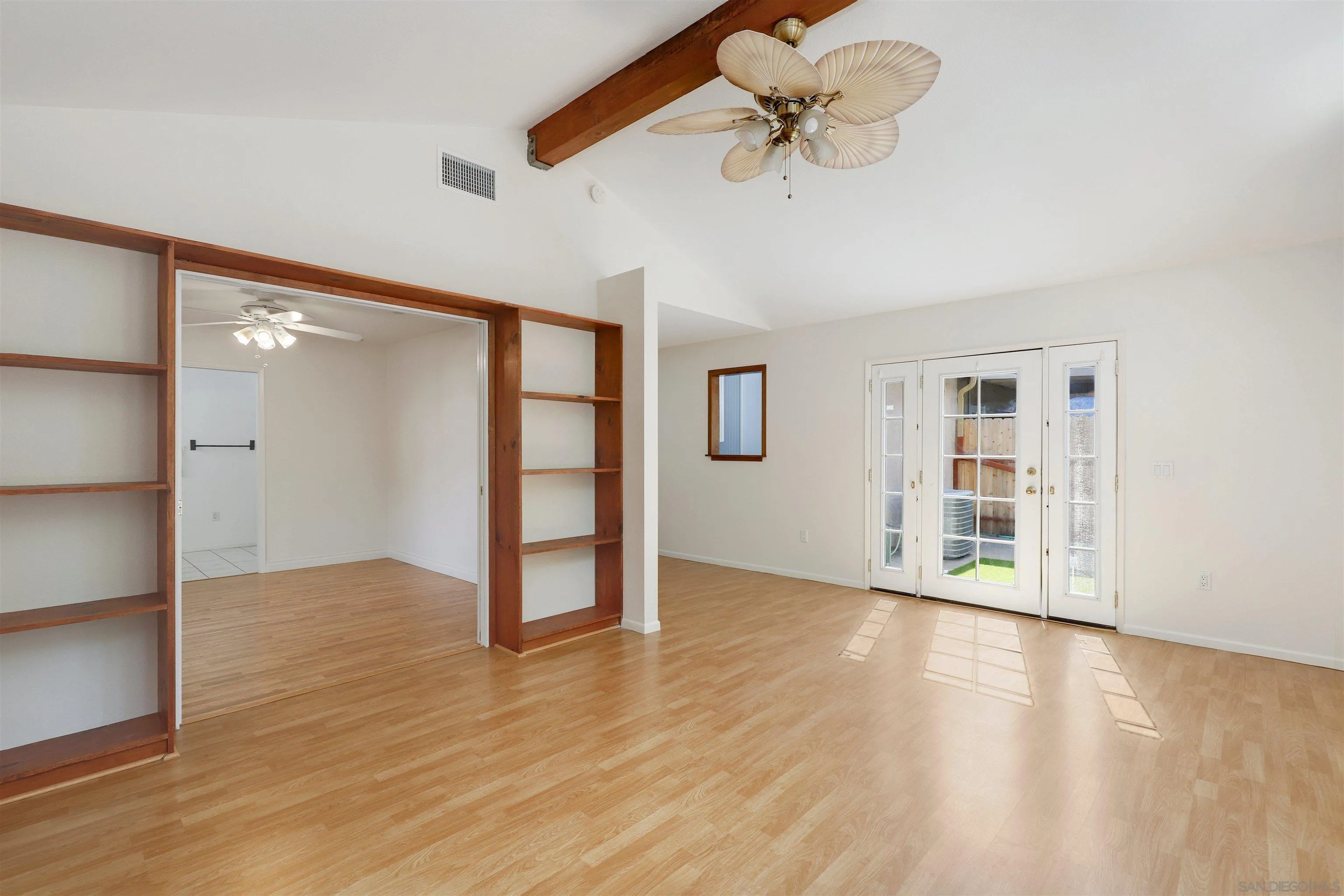 4716 Sunrise Ridge Oceanside, CA 92056 - Photo 16 of 31 a view of an empty room with a window and wooden floor
