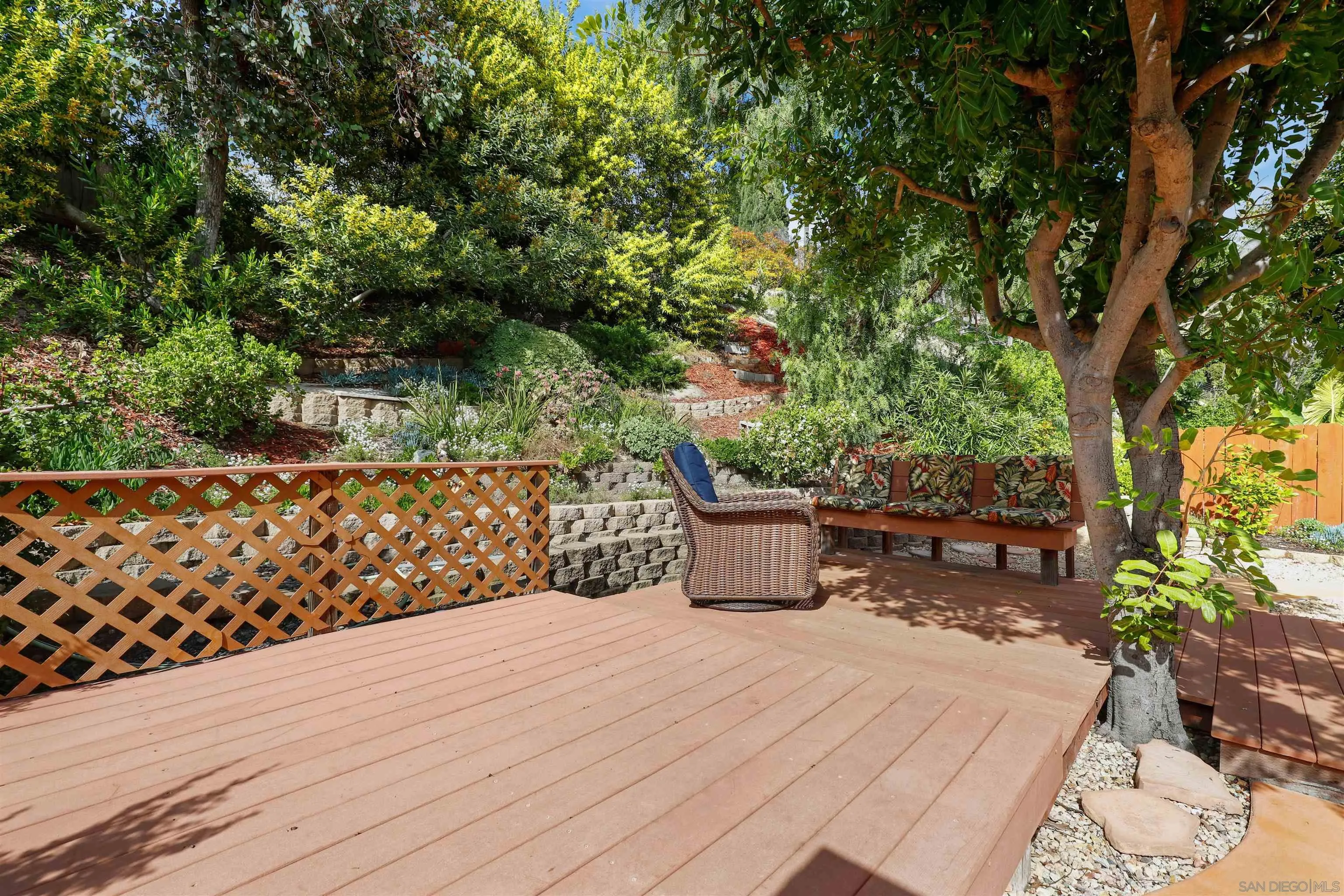 4716 Sunrise Ridge Oceanside, CA 92056 - Photo 28 of 31 a wooden bench sitting in front of a building