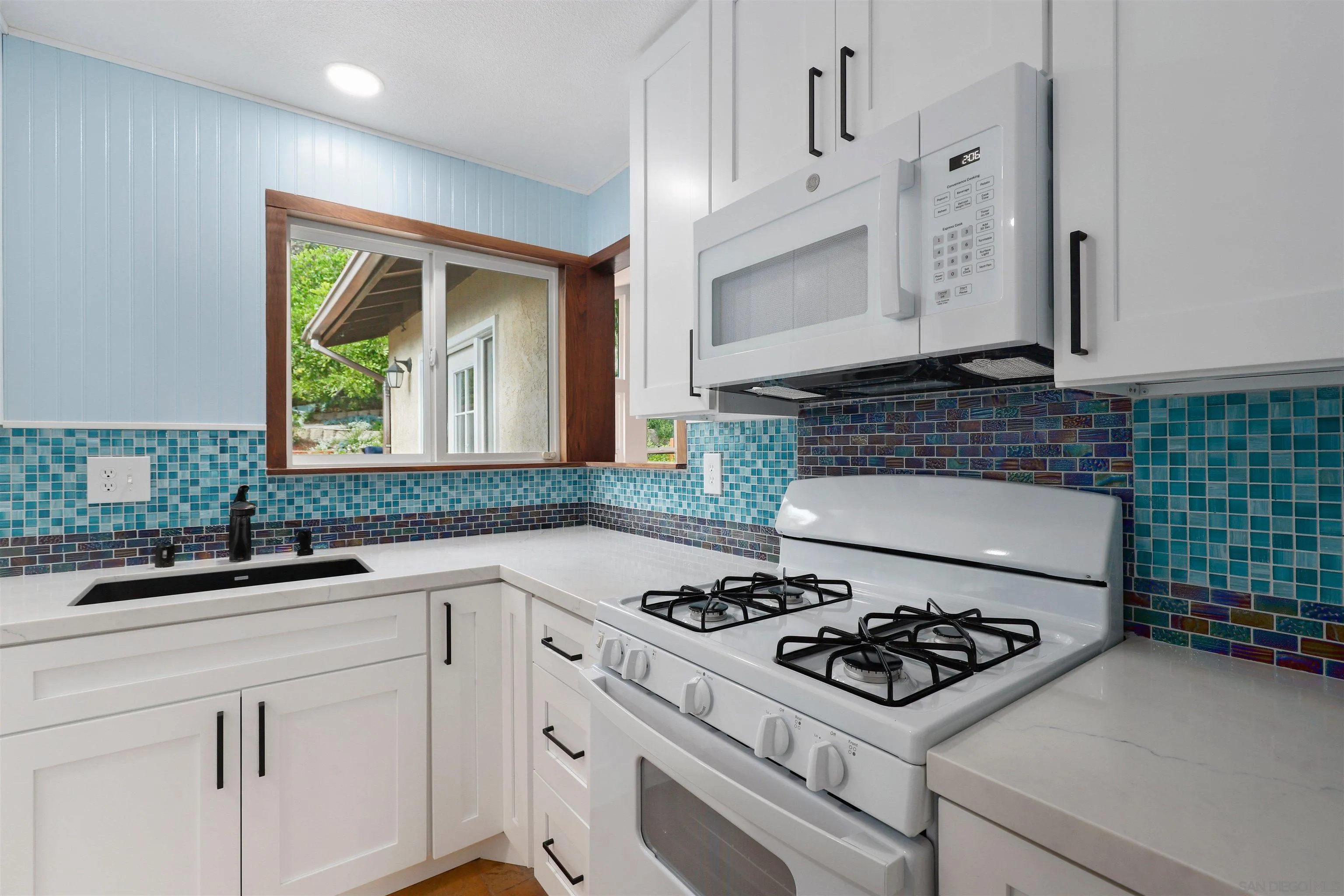 4716 Sunrise Ridge Oceanside, CA 92056 - Photo 4 of 31 a kitchen with a stove a sink and a refrigerator