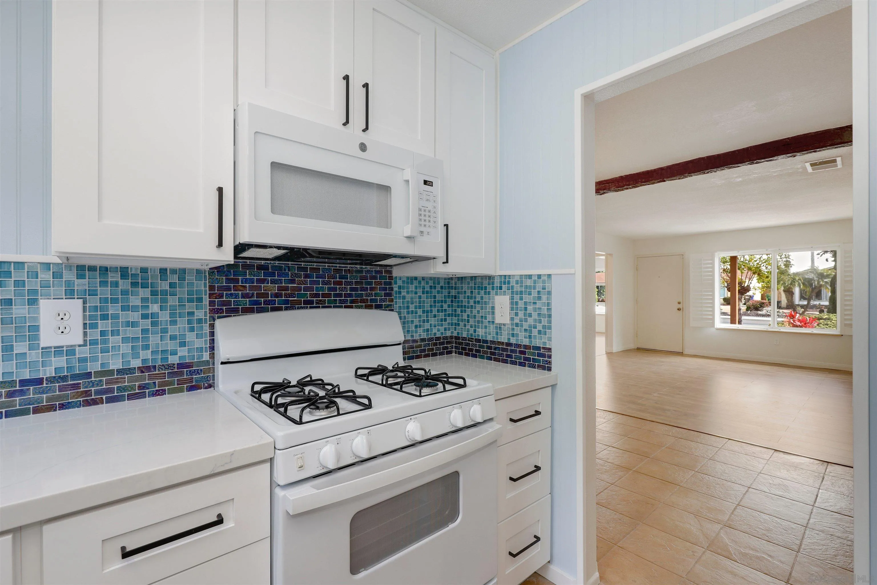 4716 Sunrise Ridge Oceanside, CA 92056 - Photo 5 of 31 a kitchen with a stove cabinets and wooden floor