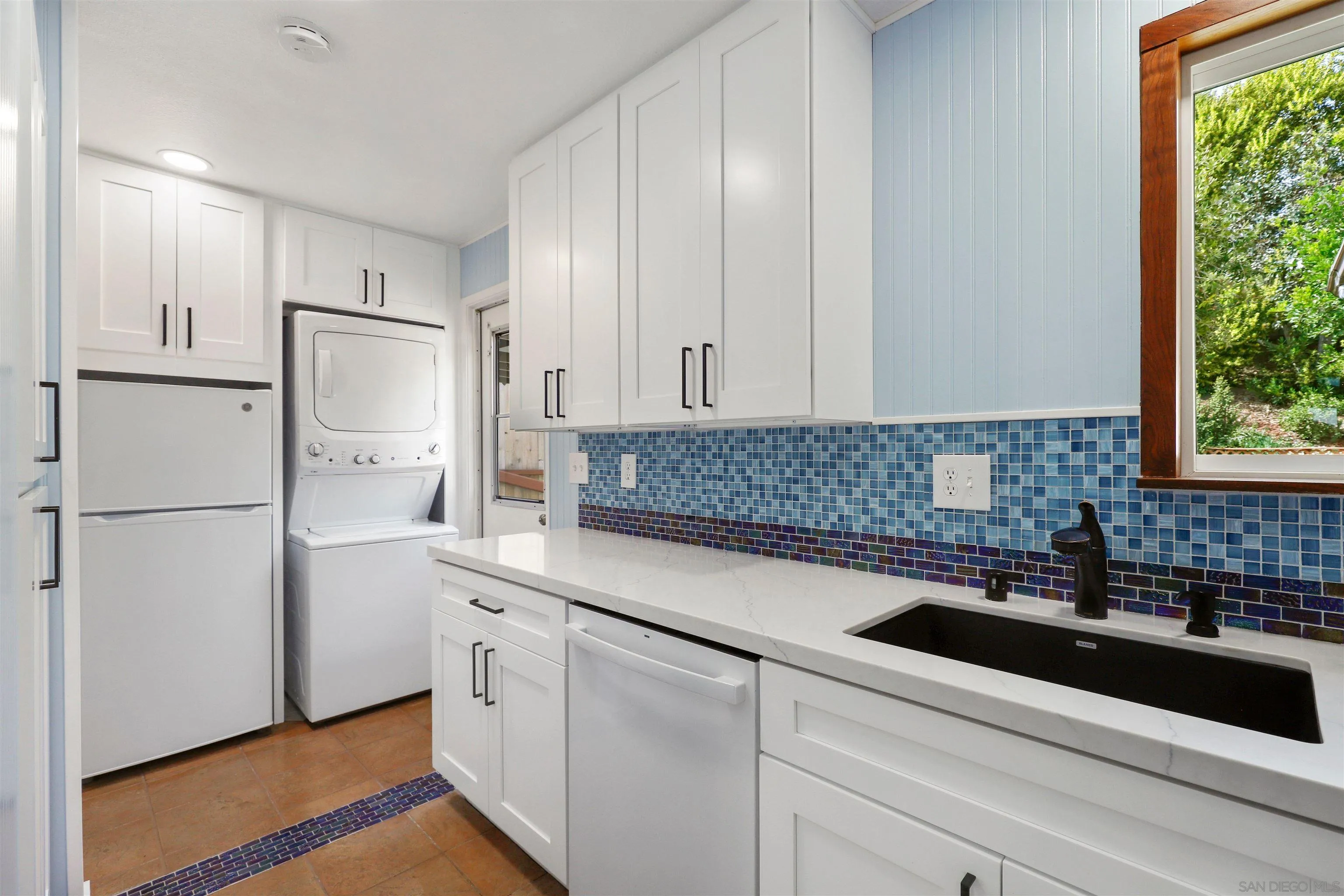 4716 Sunrise Ridge Oceanside, CA 92056 - Photo 6 of 31 a kitchen with white cabinets and white appliances