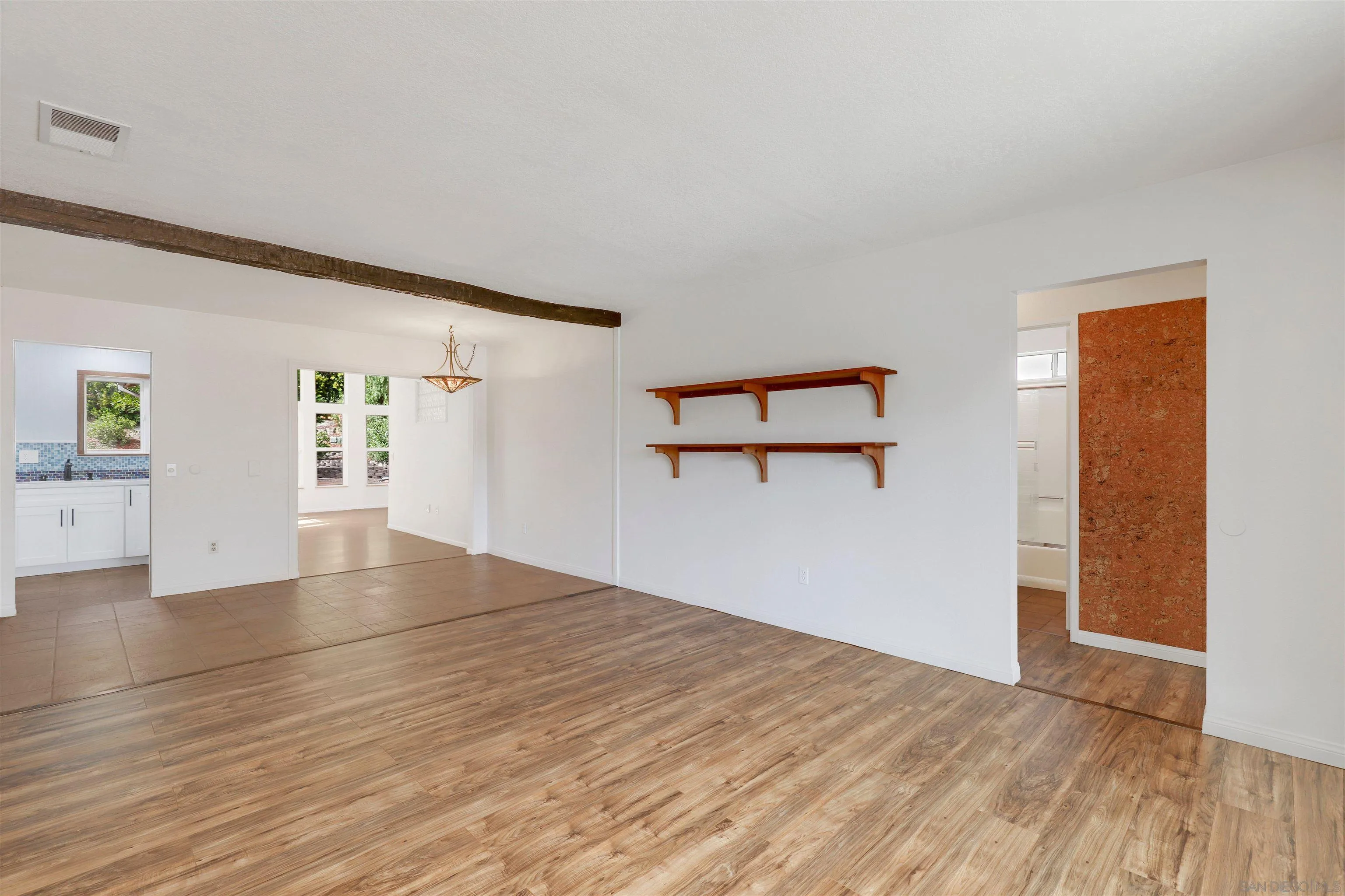 4716 Sunrise Ridge Oceanside, CA 92056 - Photo 9 of 31 an empty room with wooden floor and windows