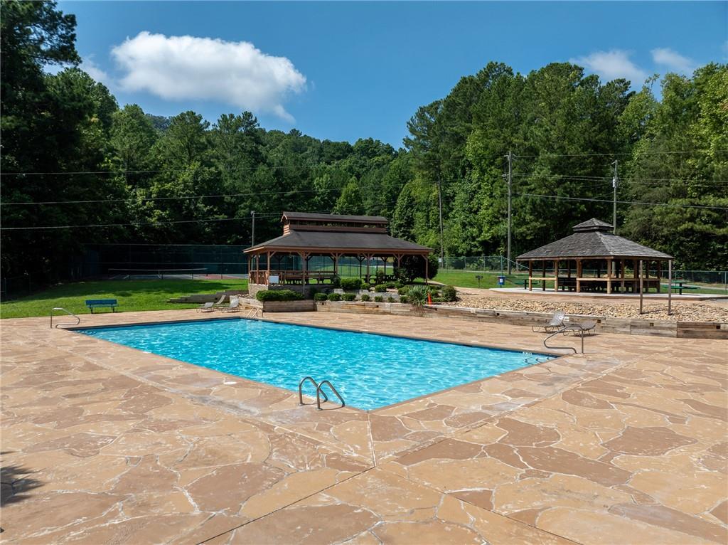 71 Geyser Court Ranger, GA 30734 - Photo 48 of 57 a view of swimming pool with lawn chairs under an umbrella