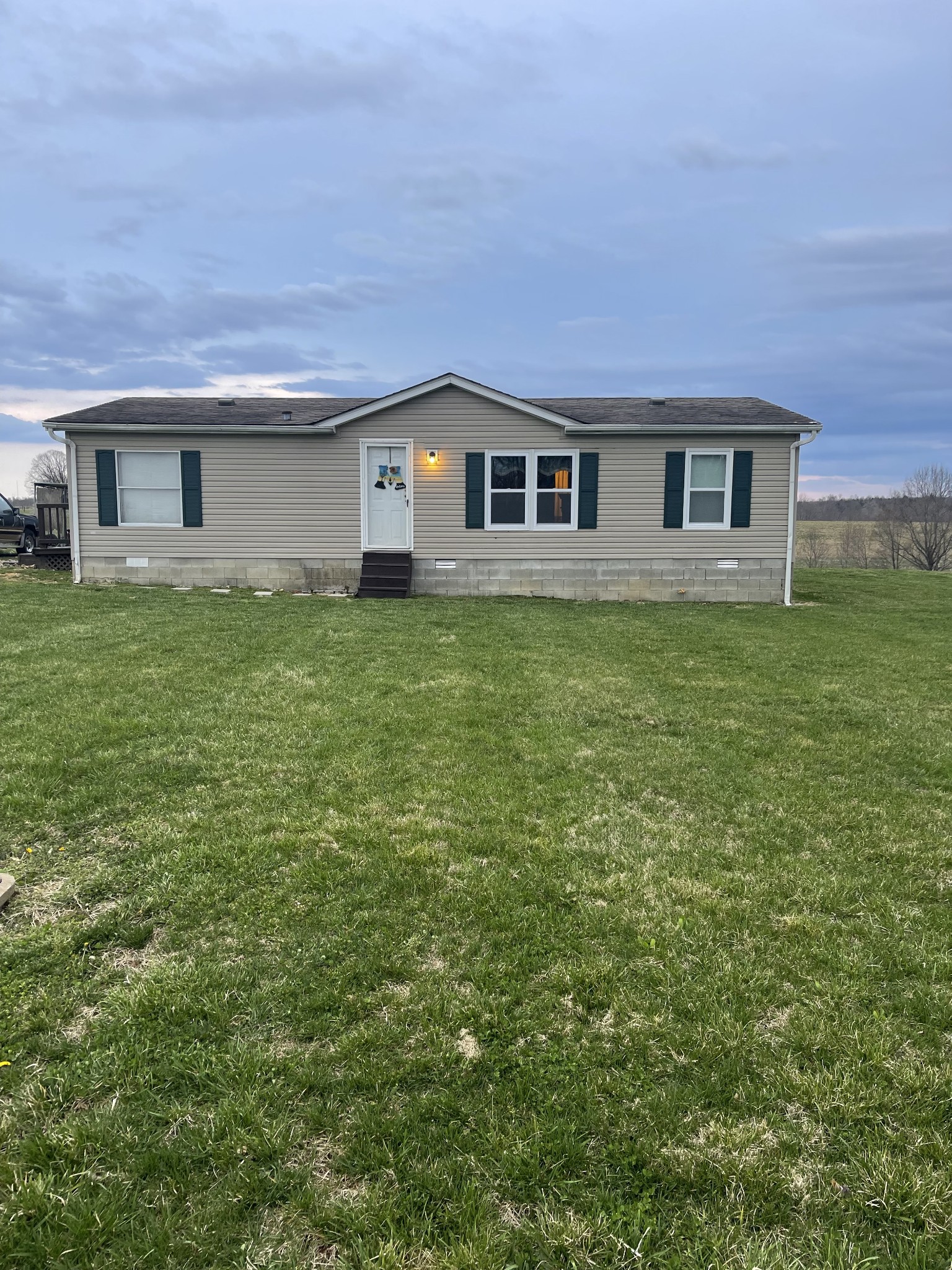 2779 Highland Road Lafayette, TN 37083 - Photo 1 of 13 a front view of a house with garden