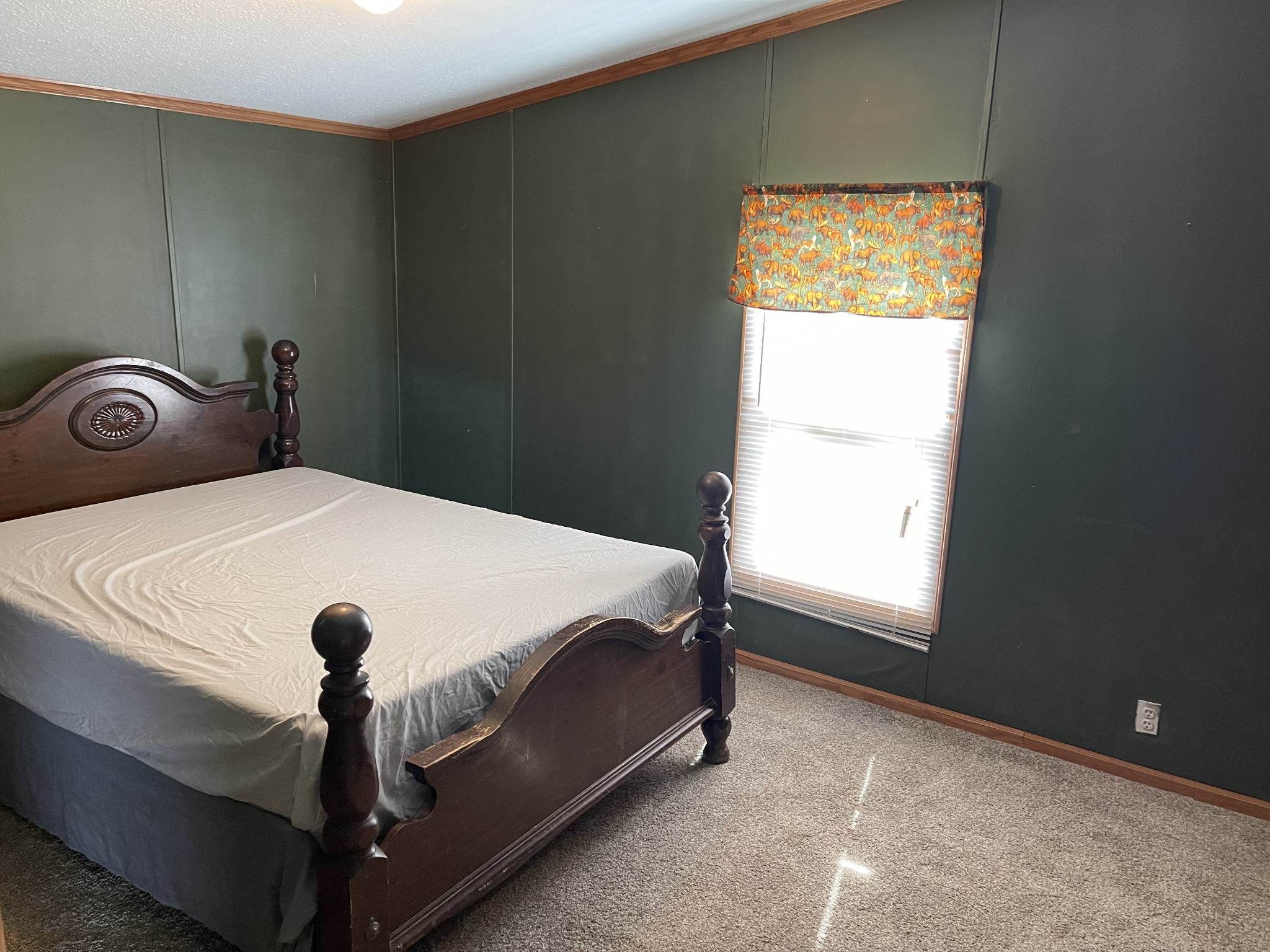 2779 Highland Road Lafayette, TN 37083 - Photo 7 of 13 a bed sitting in a bedroom next to a window