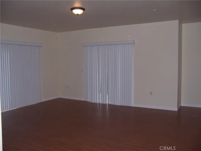 an empty room with wooden floor