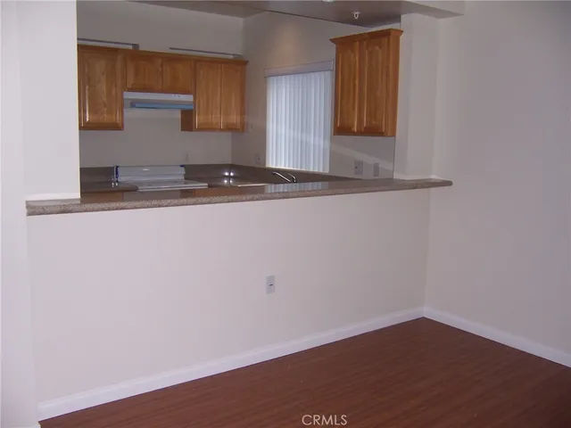 a view of a kitchen with wooden floor and a sink