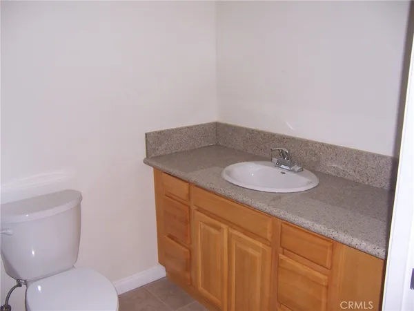 a bathroom with a sink toilet and a mirror