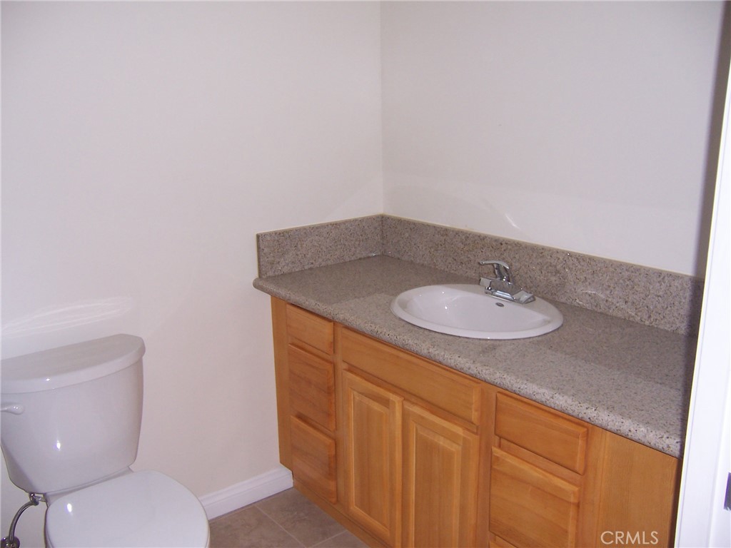4438 Vista Del Monte Avenue, Unit 202 Sherman Oaks, CA 91403 - Photo 7 of 11 a bathroom with a sink toilet and a mirror