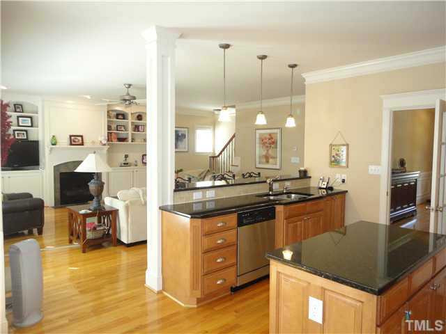 Sink side of kitchen overlooks eat-at breakfast bar and large family room - excellent for entertaining! Kitchen