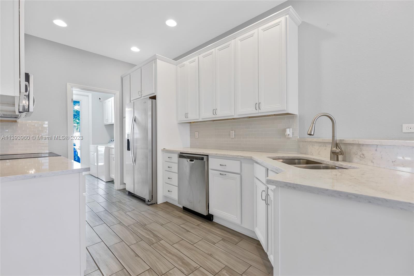 Hillcrest Hollywood, FL 33021 - Photo 6 of 30 a kitchen with a sink stove and cabinets
