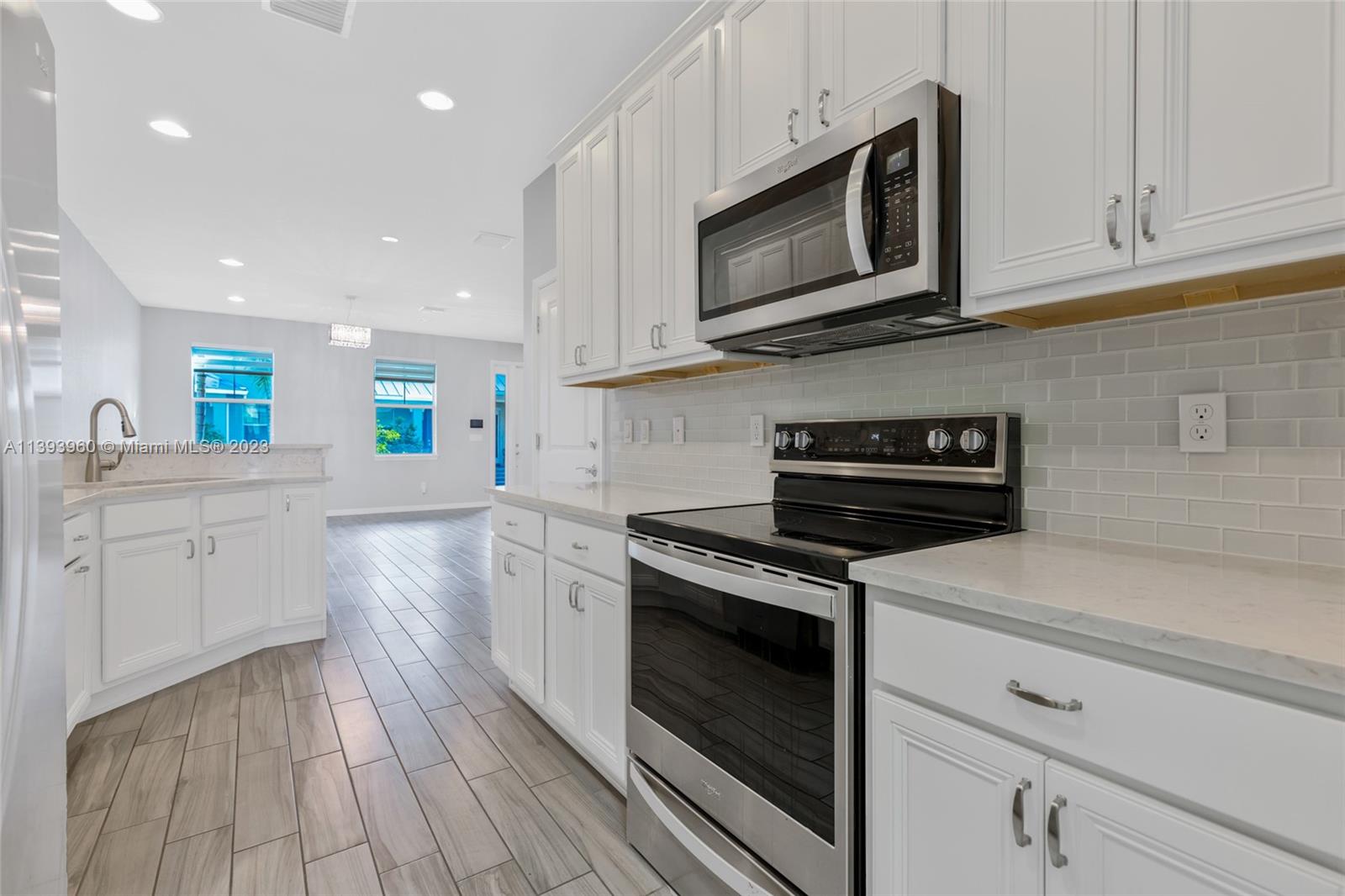 Hillcrest Hollywood, FL 33021 - Photo 7 of 30 a kitchen with stainless steel appliances granite countertop a stove microwave and sink