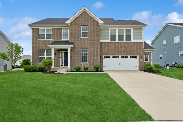 a front view of a house with a yard