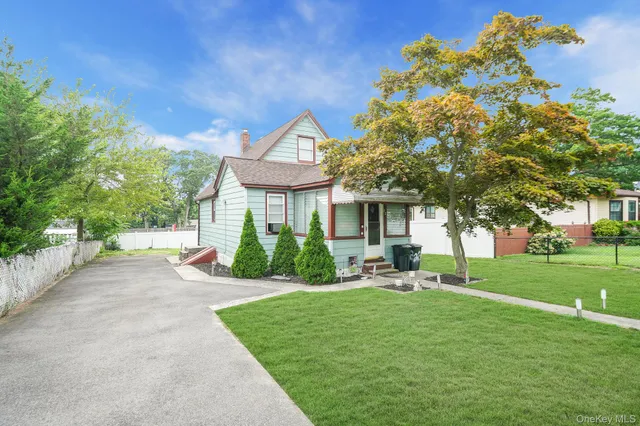 a front view of a house with a yard porch and sitting area