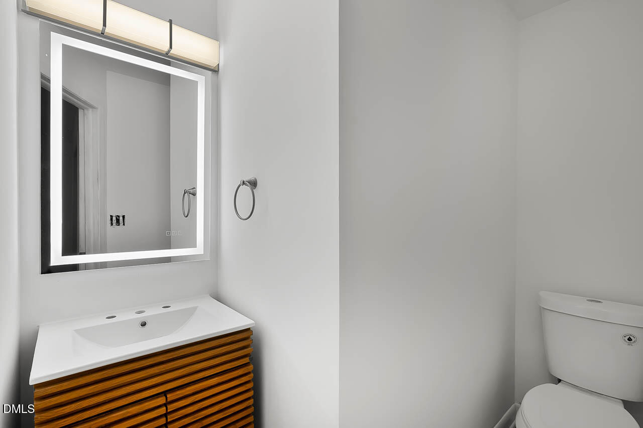 3508 Old US 1 Highway New Hill, NC 27562 - Photo 12 of 23 a bathroom with a sink mirror and toilet