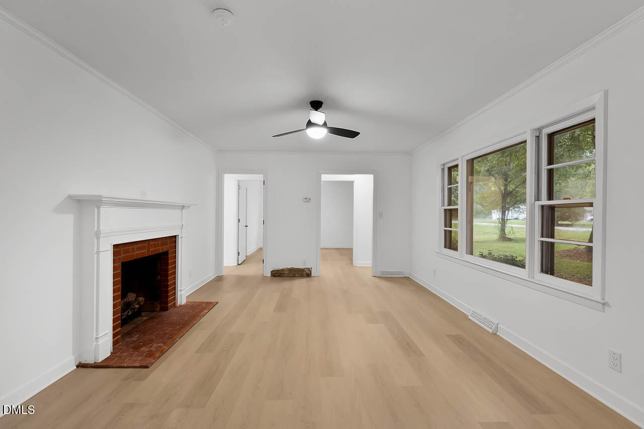 3508 Old US 1 Highway New Hill, NC 27562 - Photo 14 of 23 a view of an empty room with a fireplace and a window