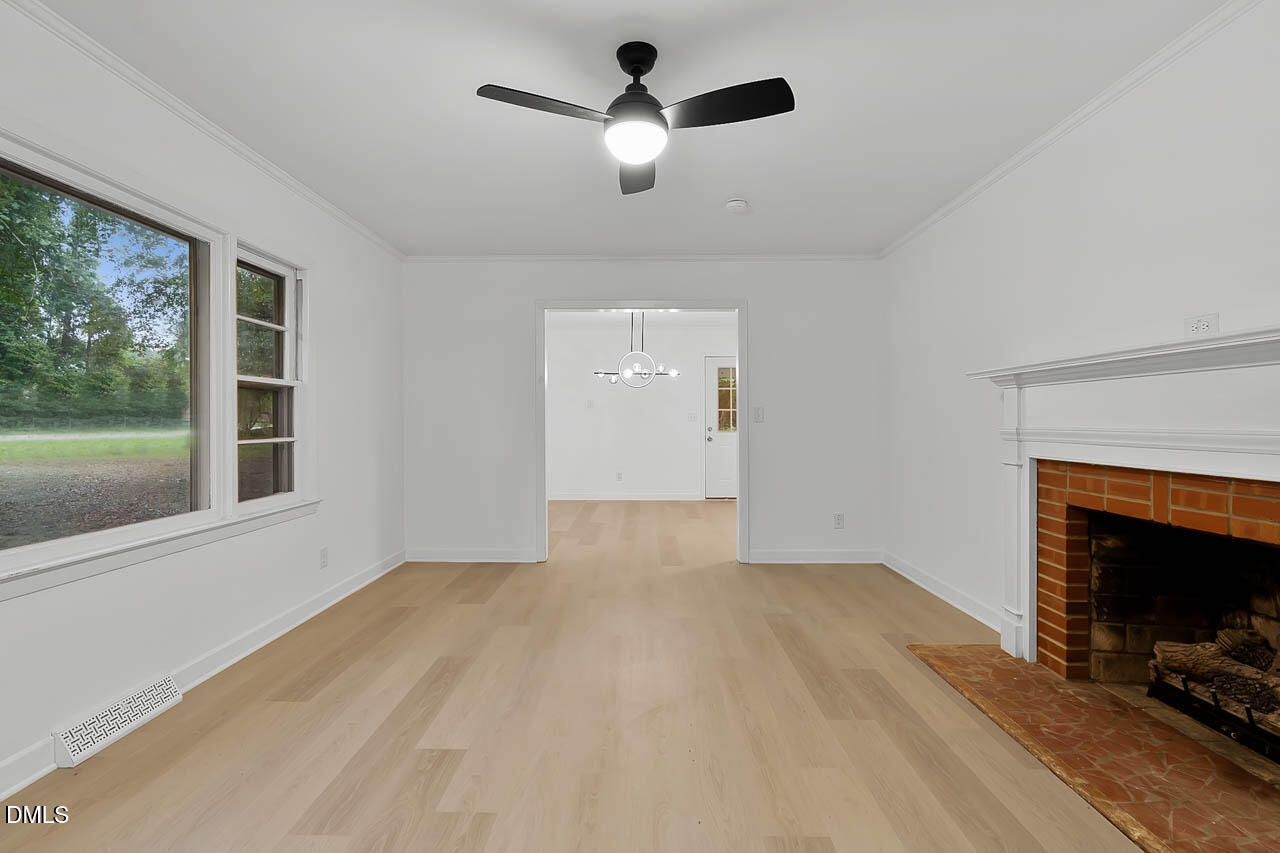 3508 Old US 1 Highway New Hill, NC 27562 - Photo 15 of 23 a view of empty room with fireplace and window