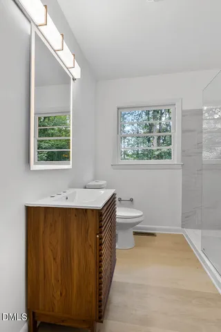 a bathroom with a shower and a toilet