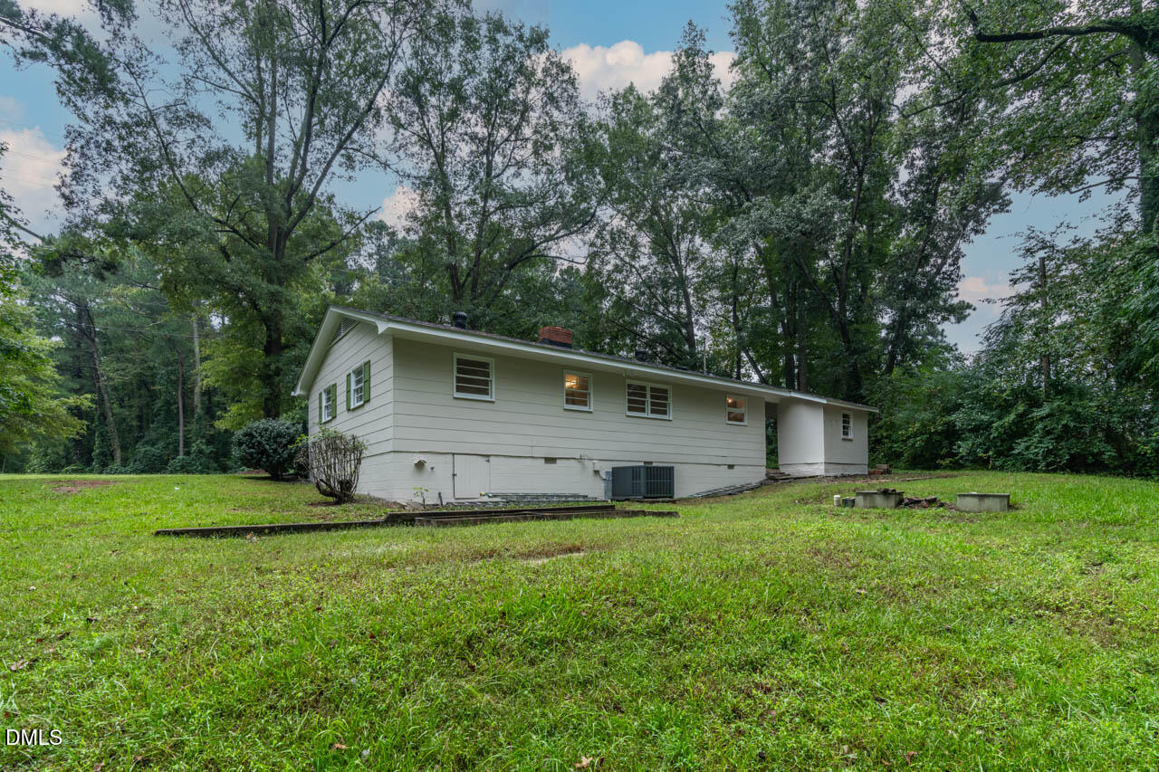 3508 Old US 1 Highway New Hill, NC 27562 - Photo 4 of 23 a house that is sitting in the grass with large trees