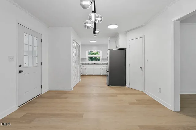 a view of a kitchen with a sink and stainless steel appliances