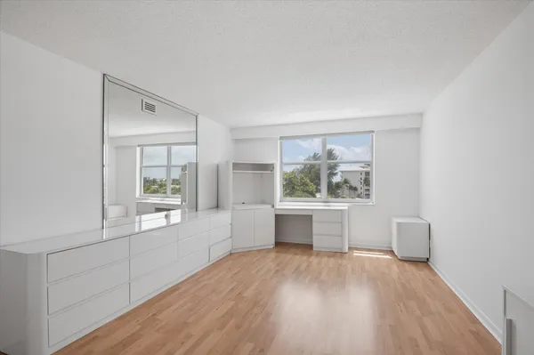a living room with wooden floors and white walls